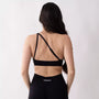 Top sportivo monospalla nero da donna indossato dal design moderno ed essenziale, con supporto confortevole e tessuto elasticizzato. 