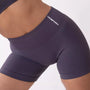 Shorts sportivi grigi da donna indossati con fascia alta in vita, morbidi ed elasticizzati.