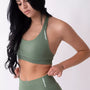 Top sportivo verde salvia da donna indossato dal design essenziale e confortevole, ideale per fitness, palestra, yoga e pilates.