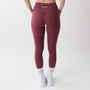 Leggings sportivi rossi da donna indossati a vita alta: tessuto elasticizzato, morbido e confortevole per fitness, yoga, pilates e allenamenti di ogni intensità.