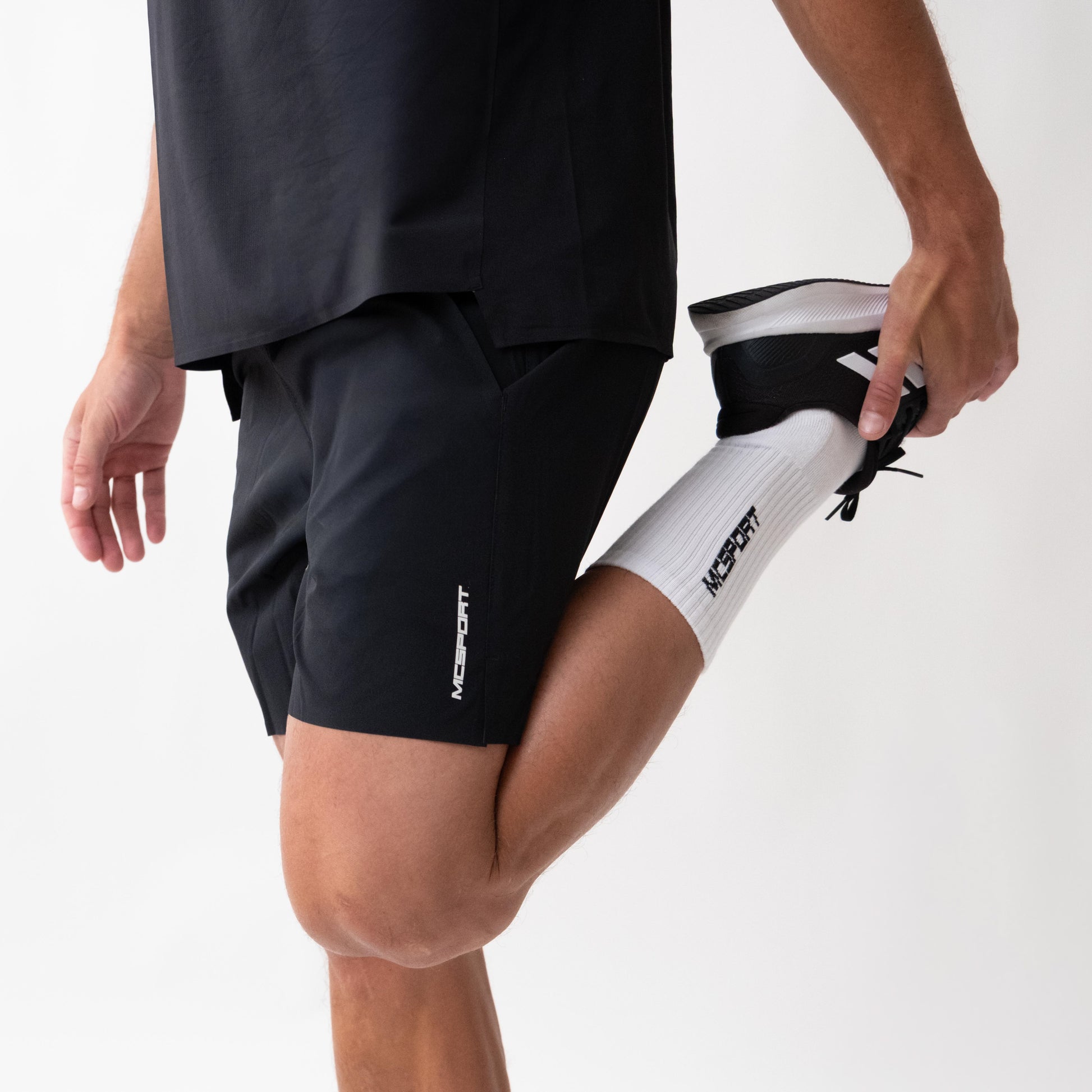 Pantaloncini neri sportivi da uomo indossati con tessuto 4-way stretch, ventilazione laser, tasca con zip e massimo comfort per ogni allenamento.